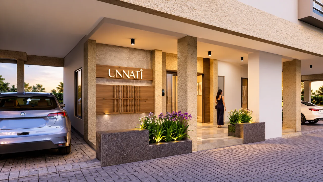 The Unnatii entrance lobby at dusk: the illuminated Unnatii sign on timber cladding, textured stone pillars and lit planters